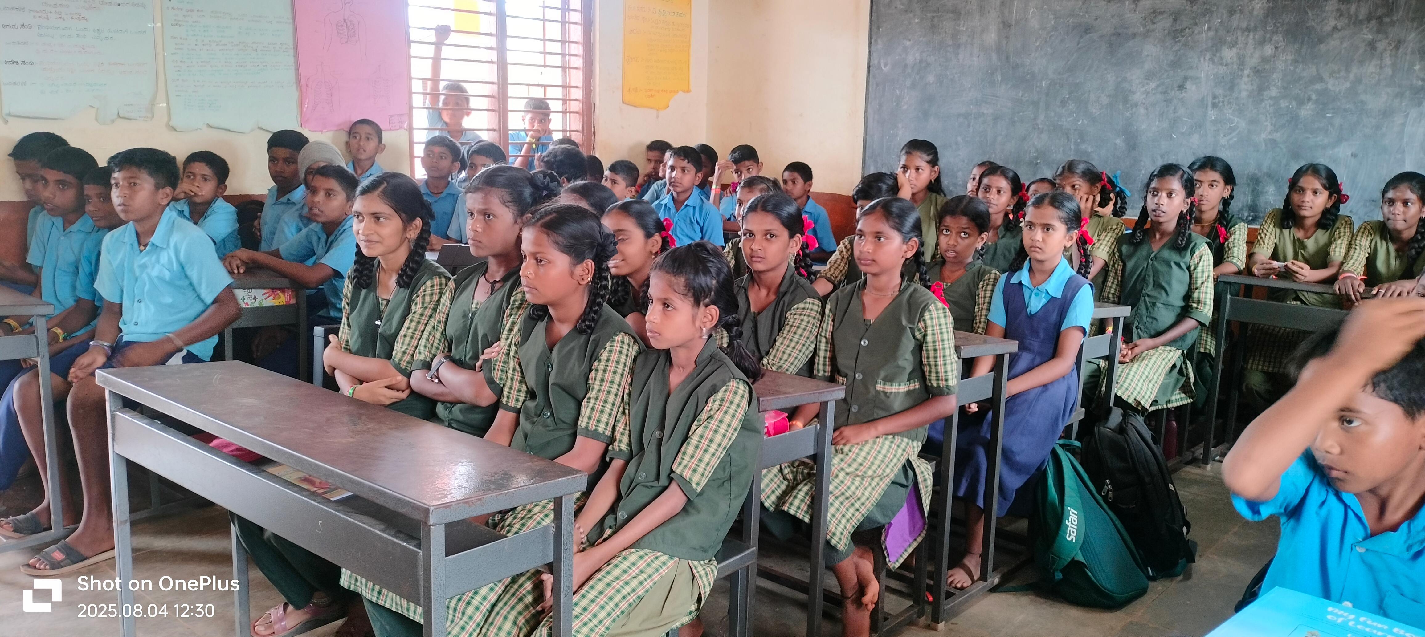 Students in different colored uniforms engaged in classroom learning